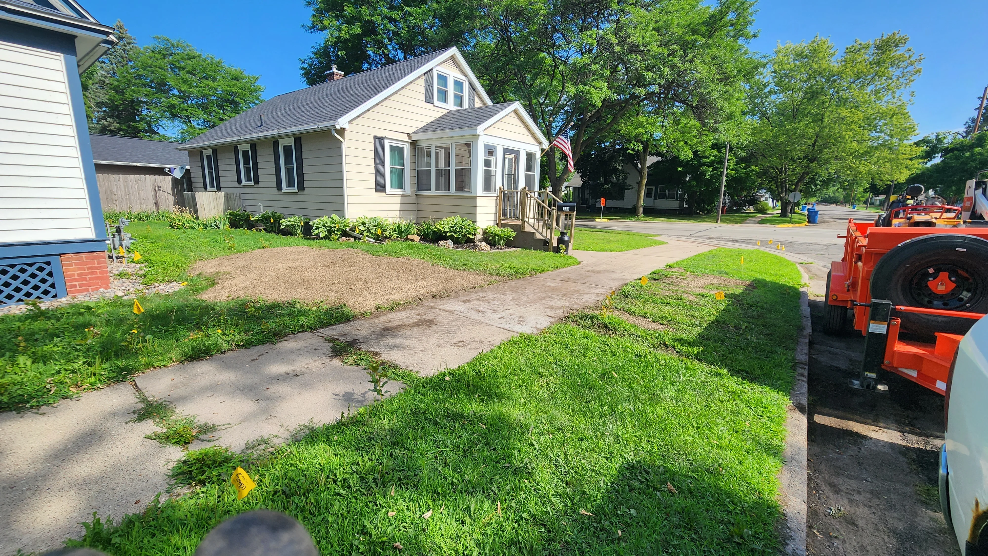 Cleared residential lot with graded soil and removal equipment, ready for landscaping